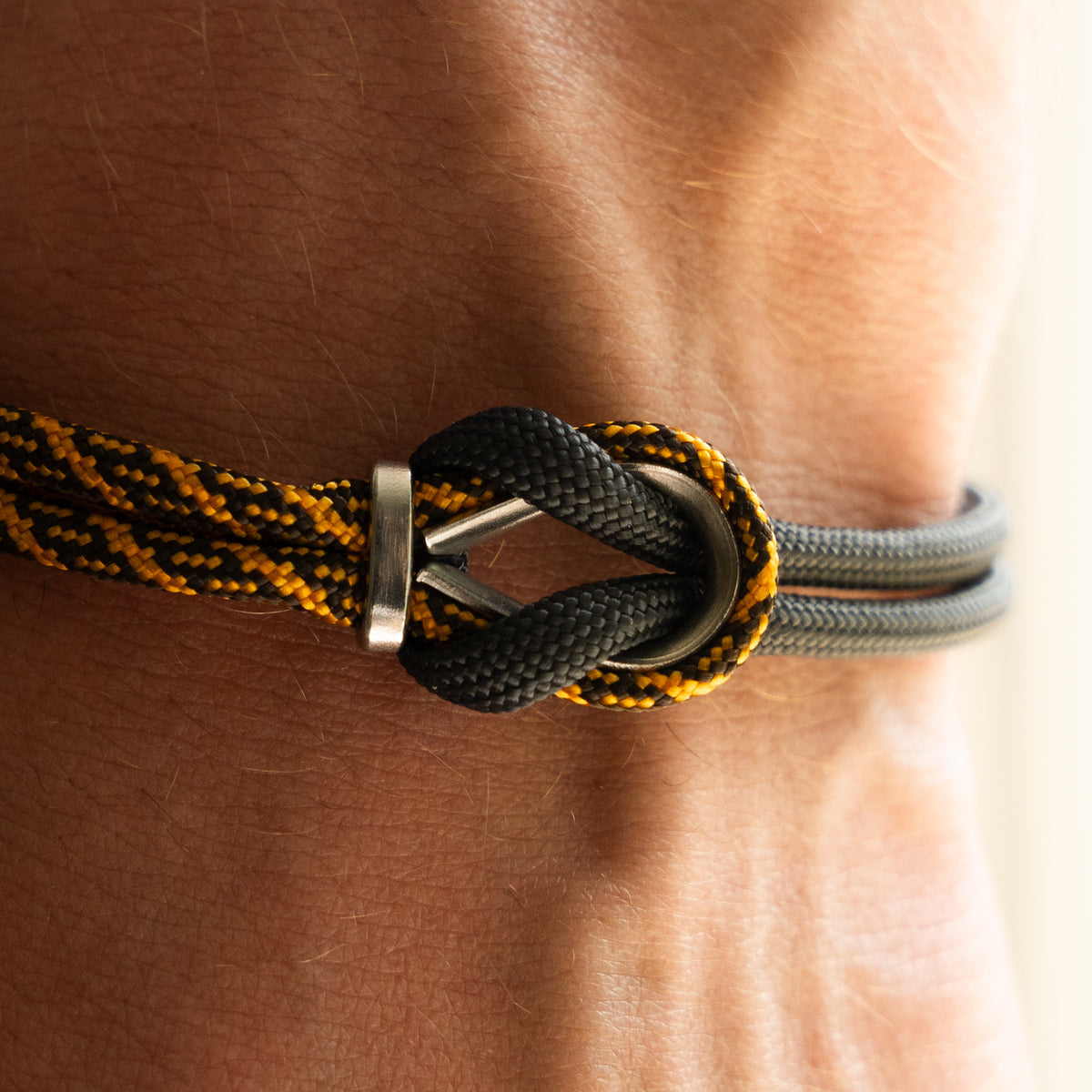 Bracciale Portofino Roccia in paracord giallo e nero indossato al polso destro, Lab93Studio